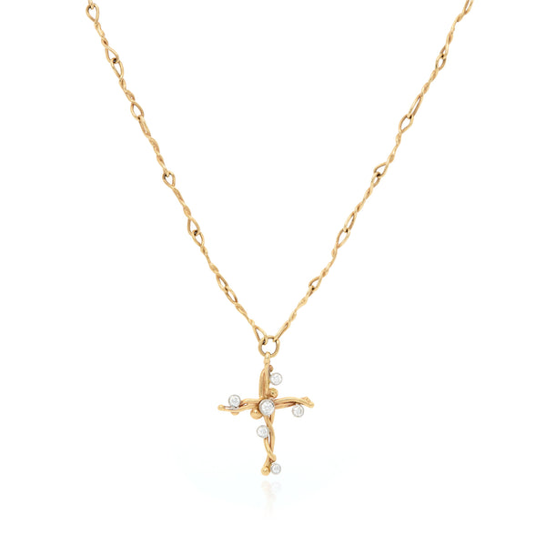 18k yellow gold small vine cross with white diamonds.