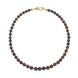 Round boulder opal bead necklace with an 18k yellow gold vine clasp.