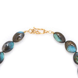 Labradorite smooth pebble necklace with an 18k yellow gold vine clasp.