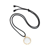 Rock crystal "looking glass" pendant in 18k yellow gold vine on black silk cord.