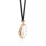 Rock crystal "looking glass" pendant in 18k yellow gold vine on black silk cord.